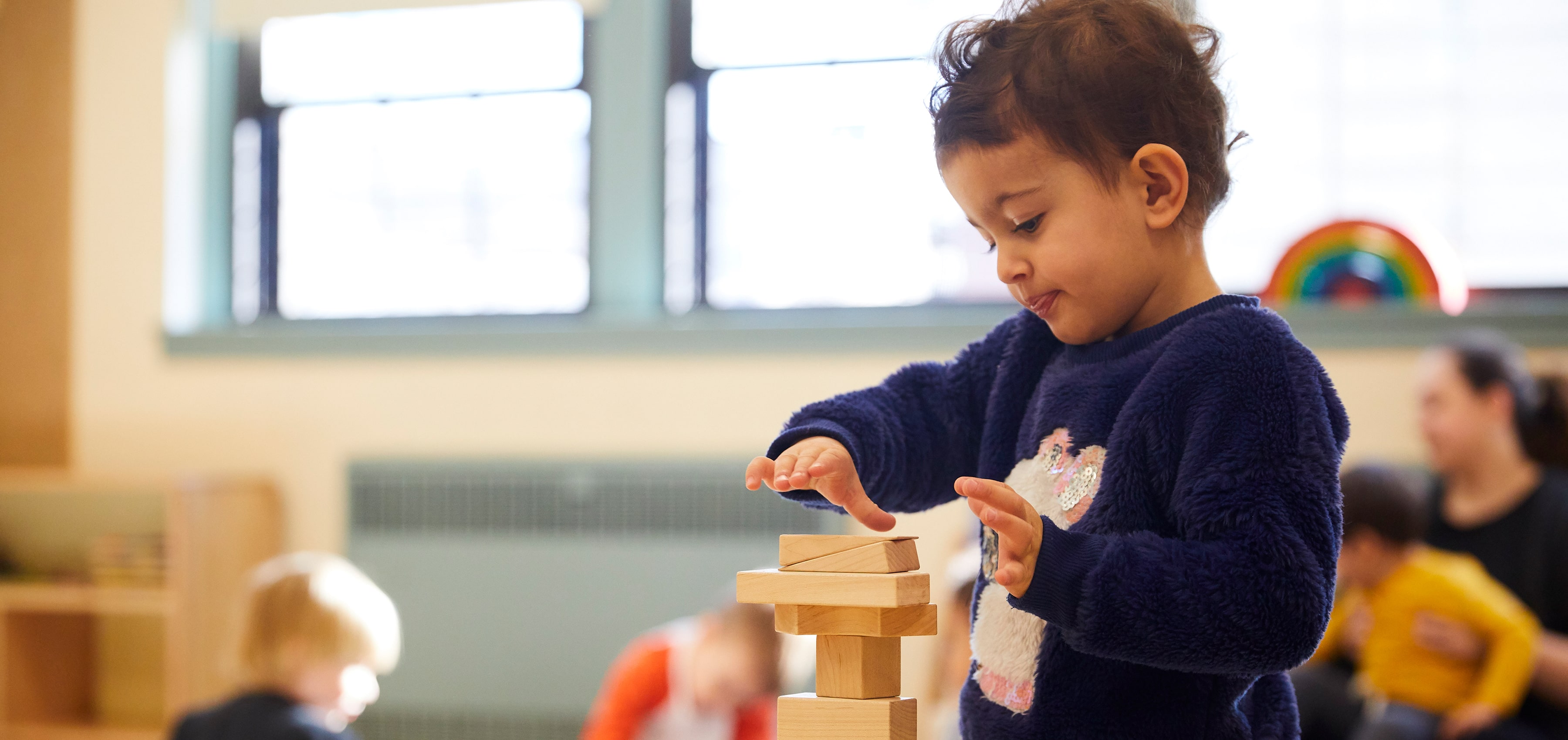 preschool student playing with blocks