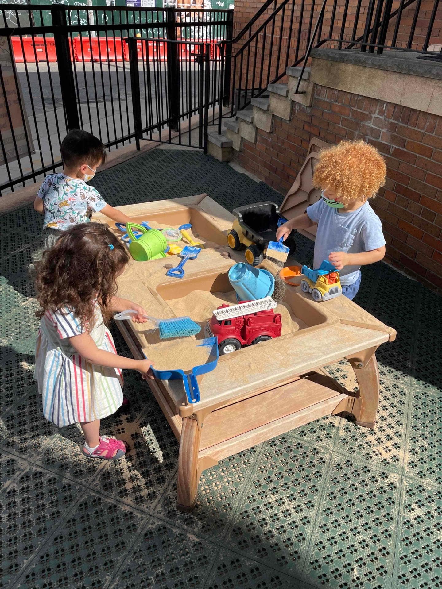 students outside with sand table
